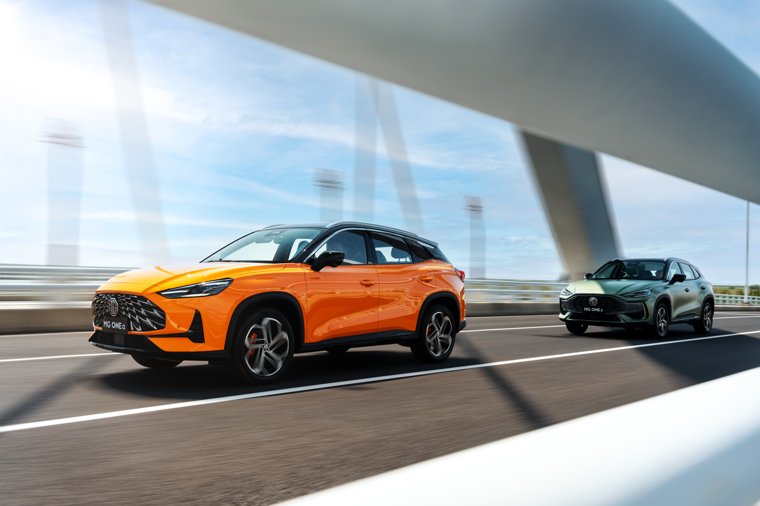 Image of orange MG One driving across a bridge