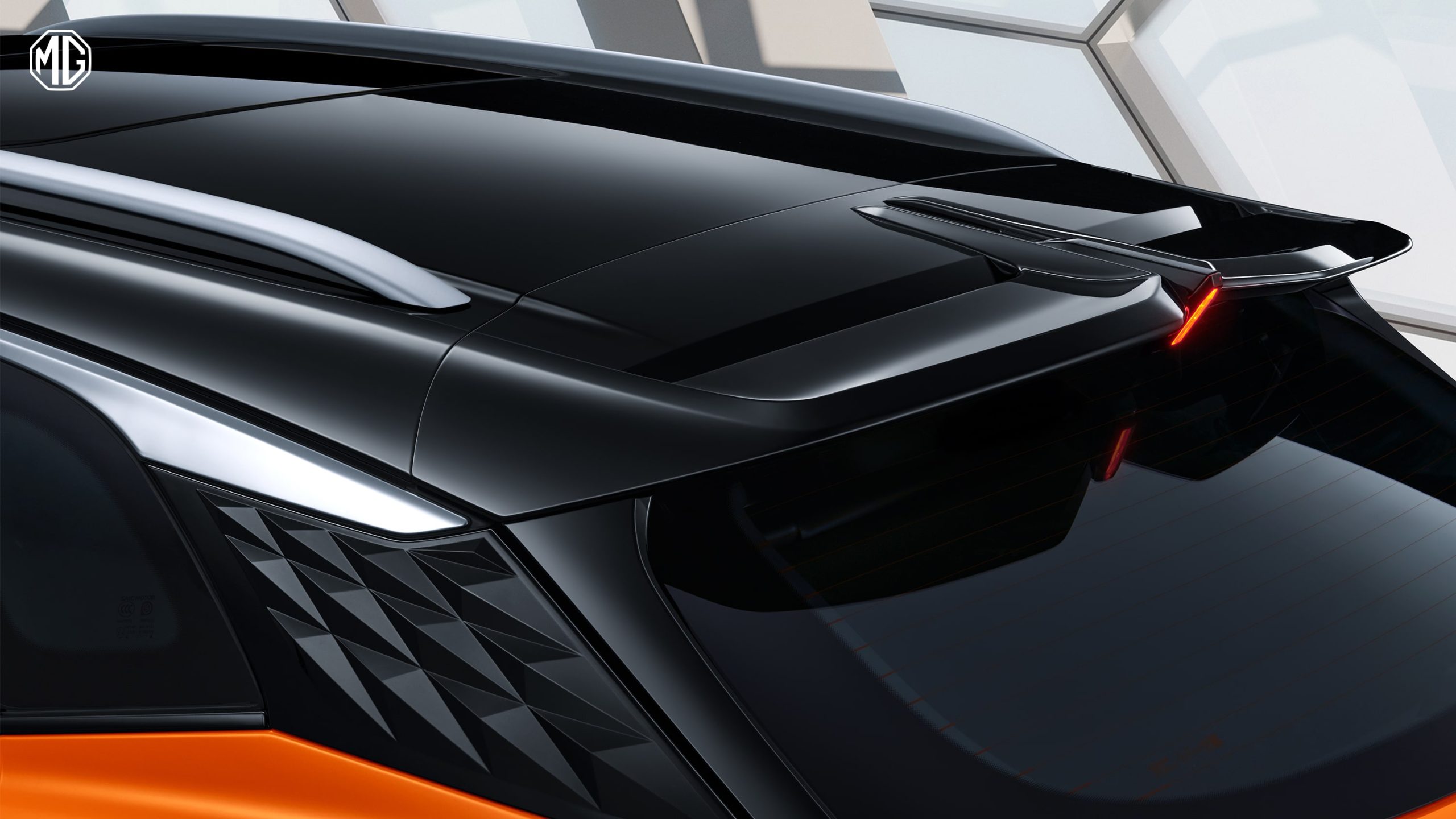 Image of the black roof rail, antenna, and high-mount stop lamp of an orange MG One